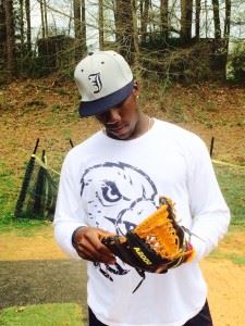 Former Jacksonville standout Shed Long checks out the glove he'll be using in his transition to second base at extended spring training with the Reds.