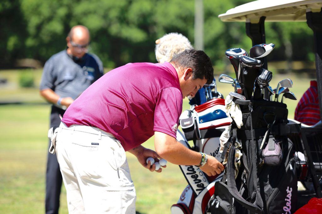 Defending amateur medalist Dalton Chandler checks his gear before stepping to the first tee Friday in the opening round of the Fort McClellan Credit Union Pro-Invitational. (Photo by Sandra Howell)