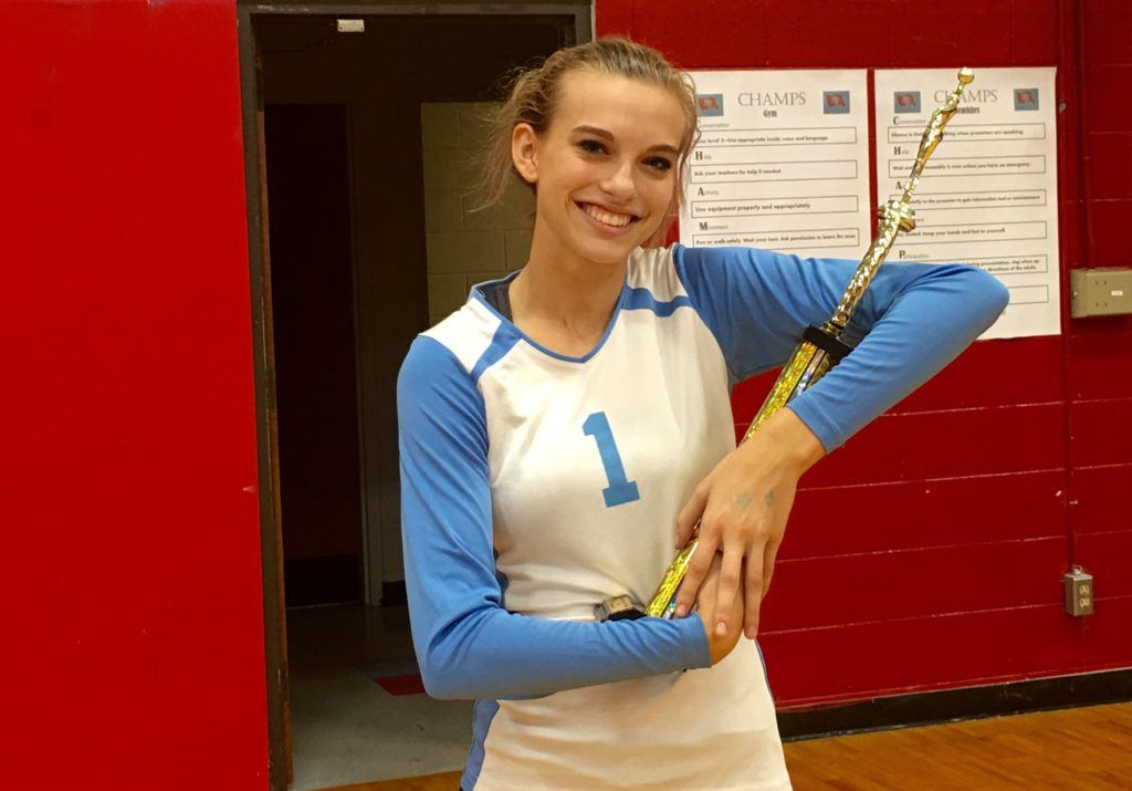 Cammy Cochran, one of two seniors on the undefeated Pleasant Valley volleyball team, cradles that trophy that went with winning Saturday's Sandy Hunter Invitational  