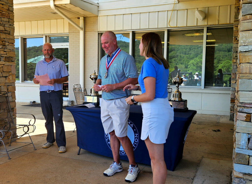 Ty Cole receives his medal Sunday after finishing second in the State Match Play championship at Anniston Country Club. (Photo by Joe Medley)